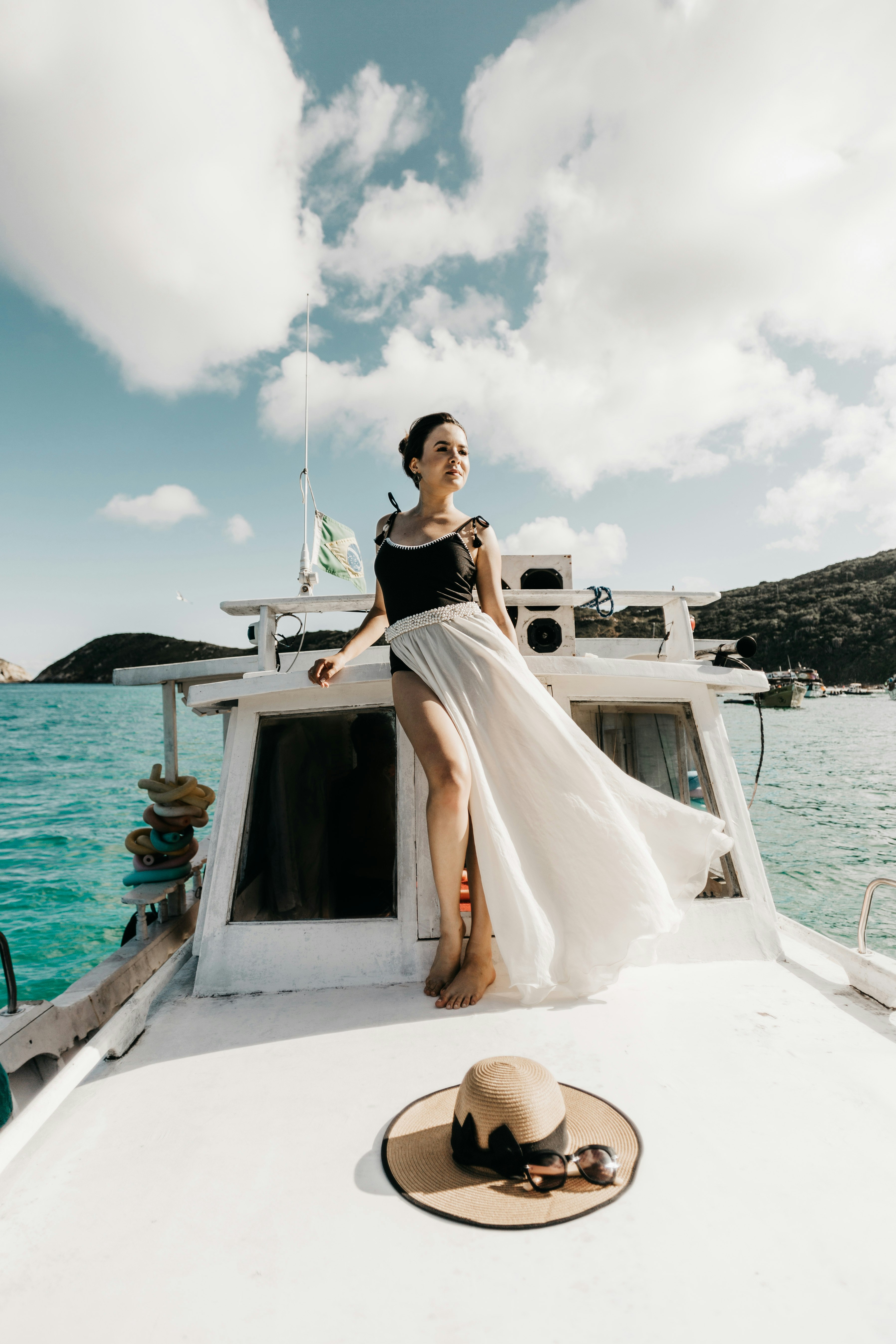 woman in white dress standing on white boat during daytime
